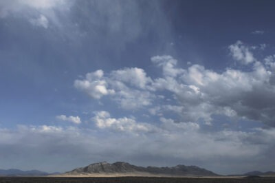 low mountains, the desert, a cloud-covered sky