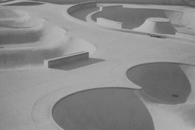 McInnis Skatepark in Northern California, rollers and bowls, no people, a single skateboard