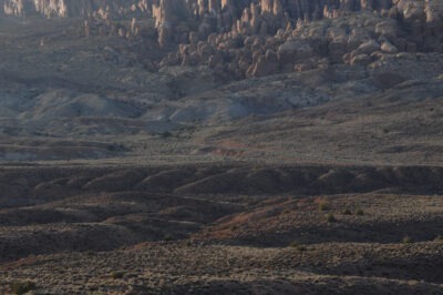 the Utah desert at twilight, sandstone formations, tiny shrubs