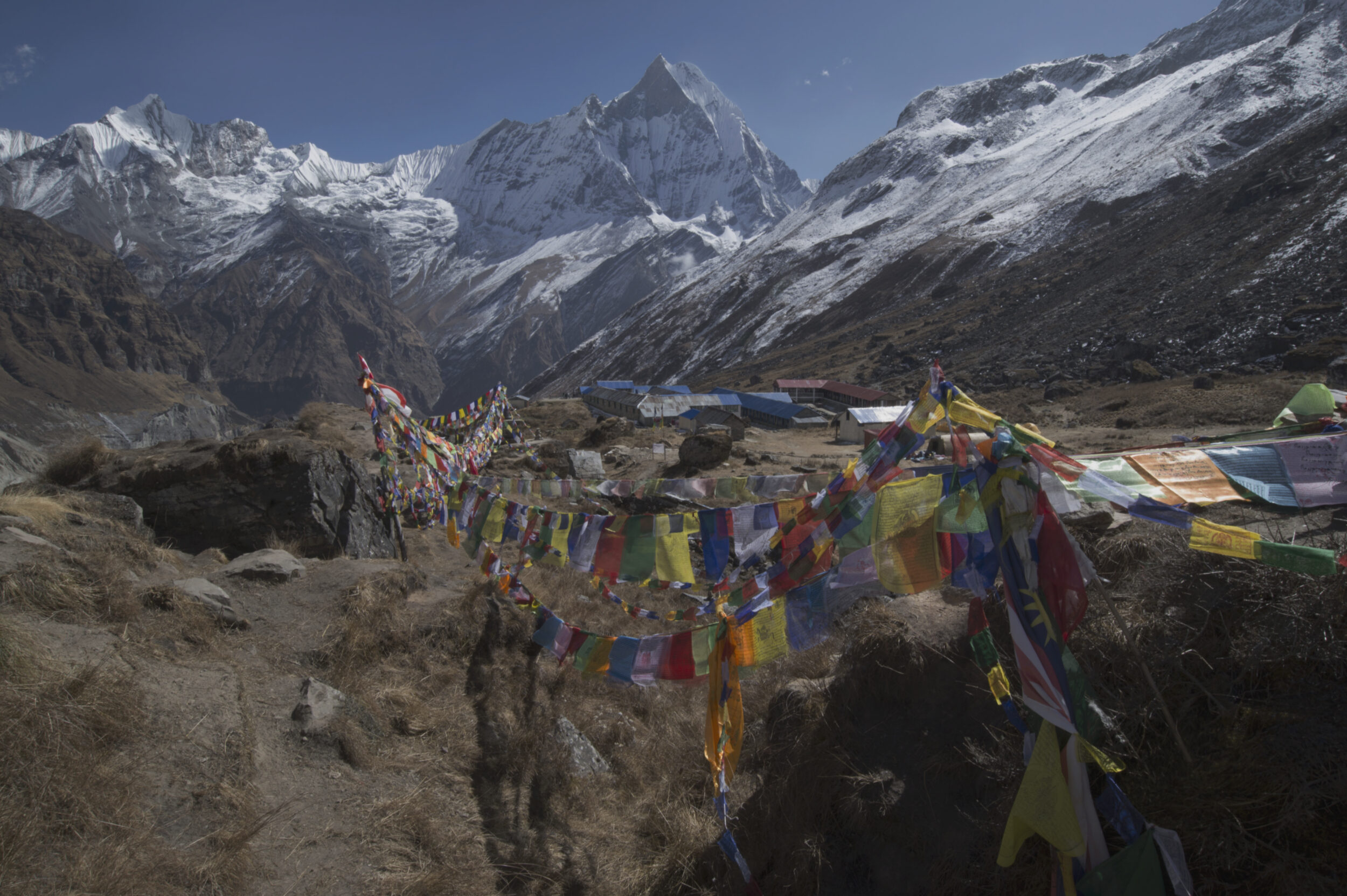 Annapurna basecamp, the lodge structures, prayer flags, and the surrounding mountains